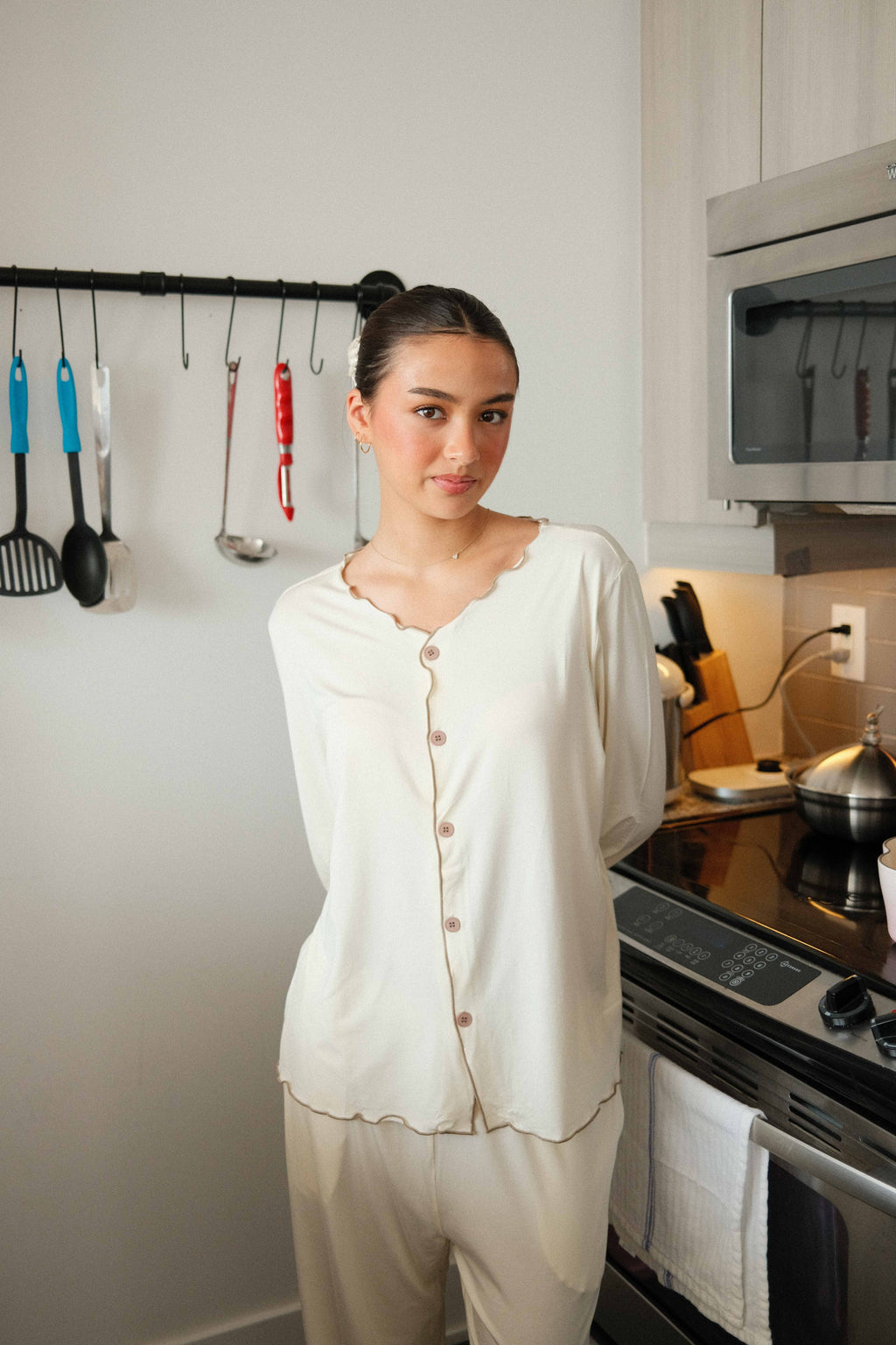 Ruffle Trim Pajama Set in Cream, on model, smiling at the kitchen counter