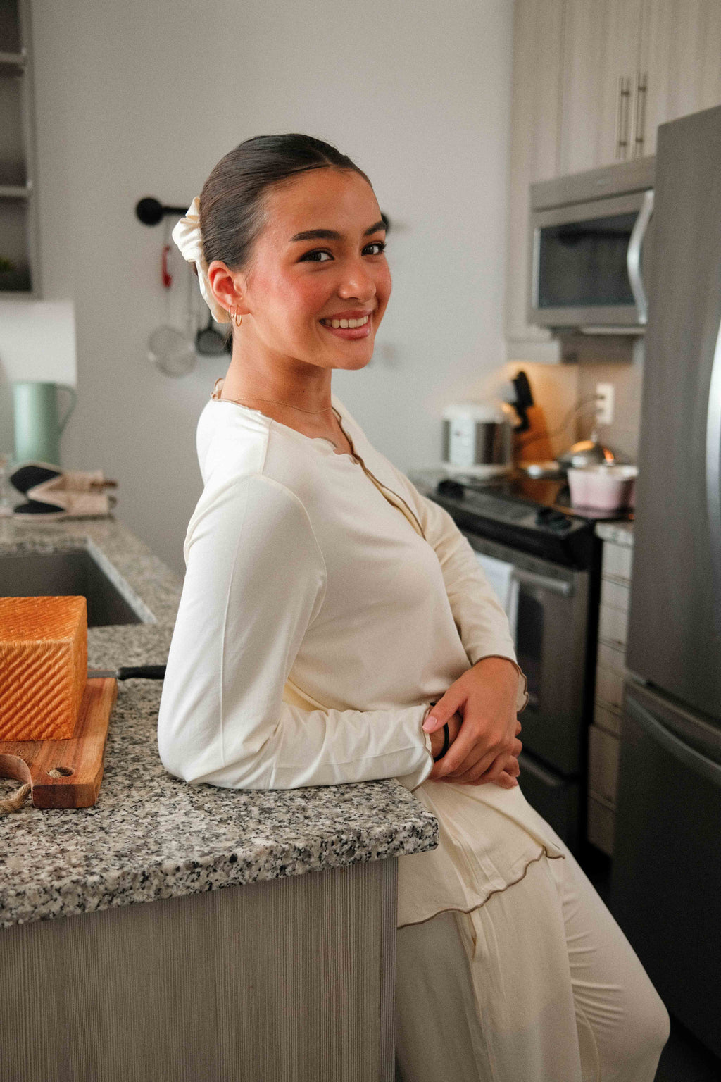 Ruffle Trim Pajama Set in Cream, on model, leaning by the fridge