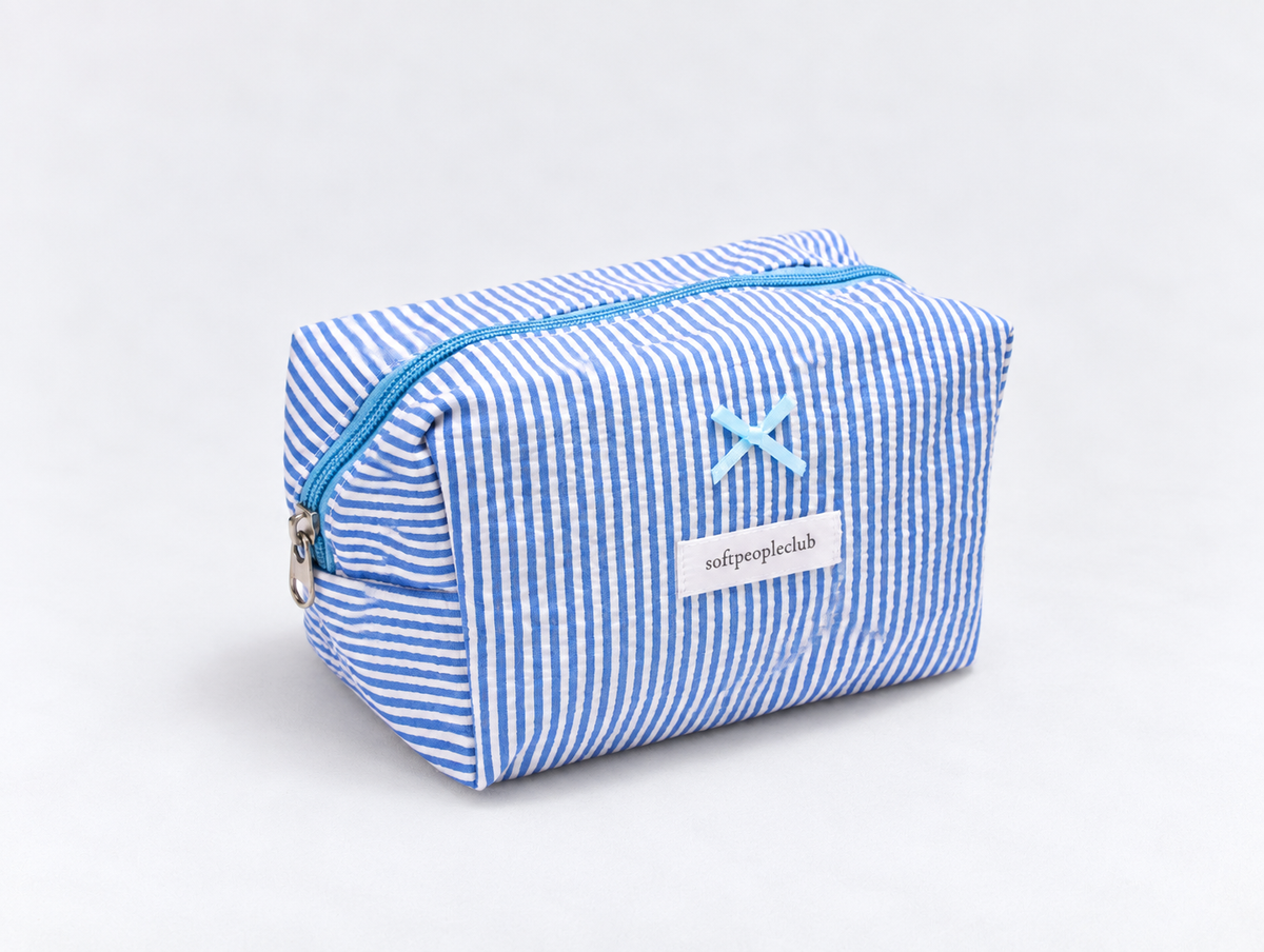 Seersucker Bow Makeup Bag in Blue Stripe, angled view