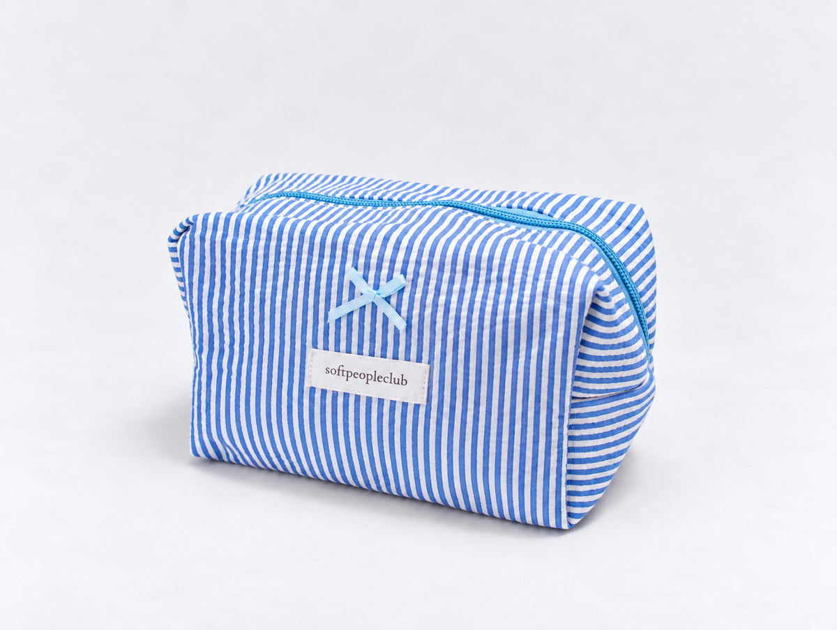 Seersucker Bow Makeup Bag in Blue Stripe, angled view