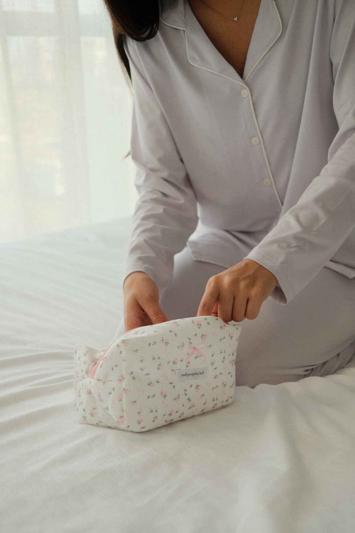 Padded Rose & Bow Makeup Bag, opened on bed, close up