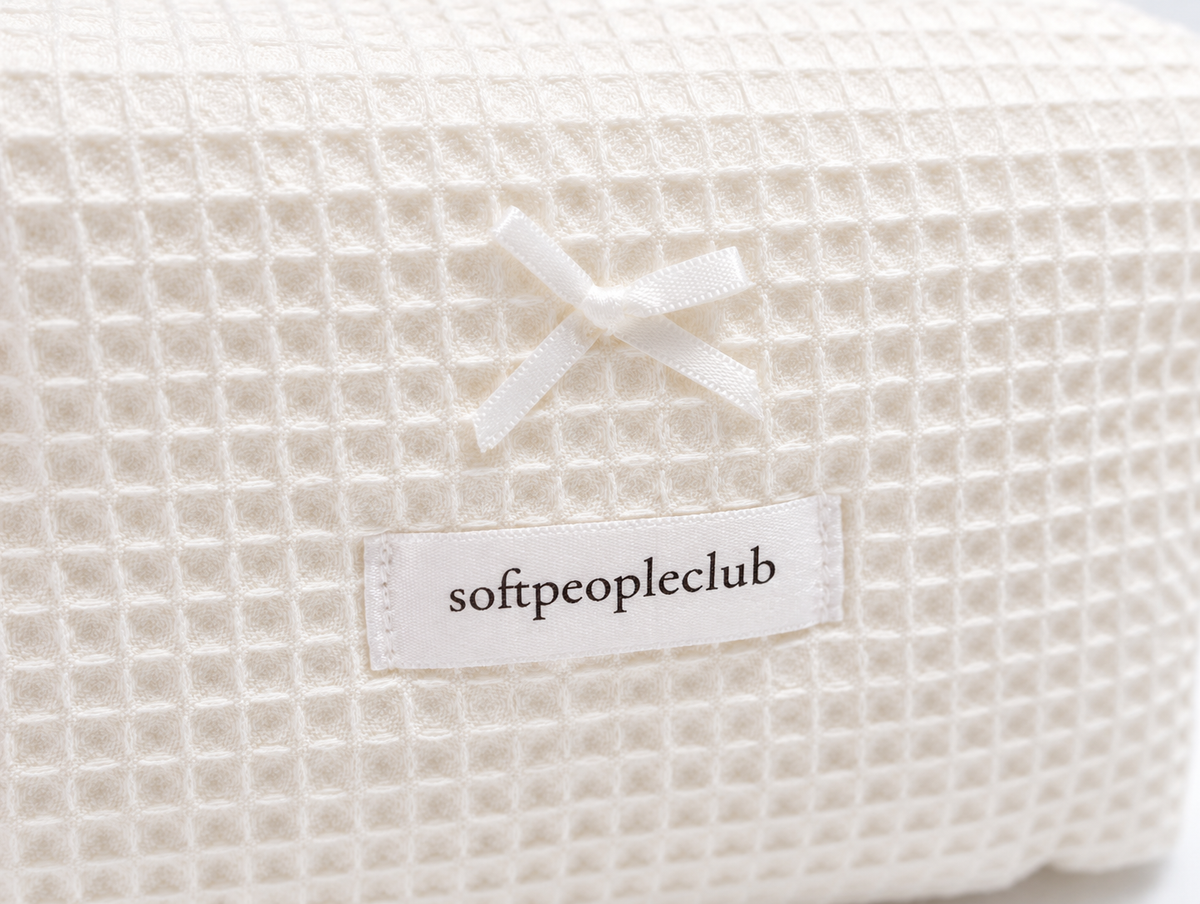 Padded Waffle Makeup Bag in Cream, bow and label detail