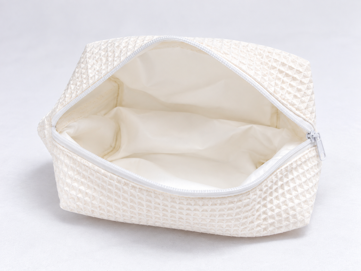 Padded Waffle Makeup Bag in Cream, open with cream lining