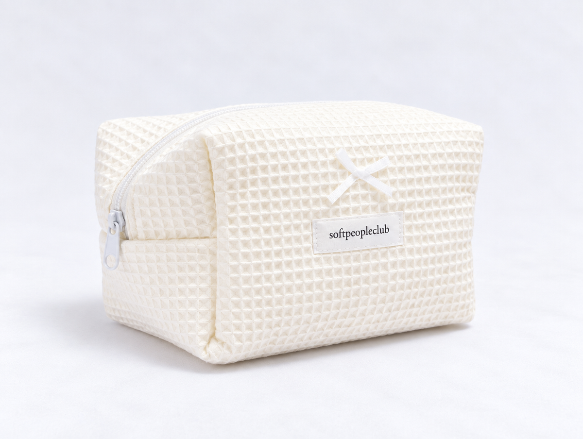 Padded Waffle Makeup Bag in Cream, angled view