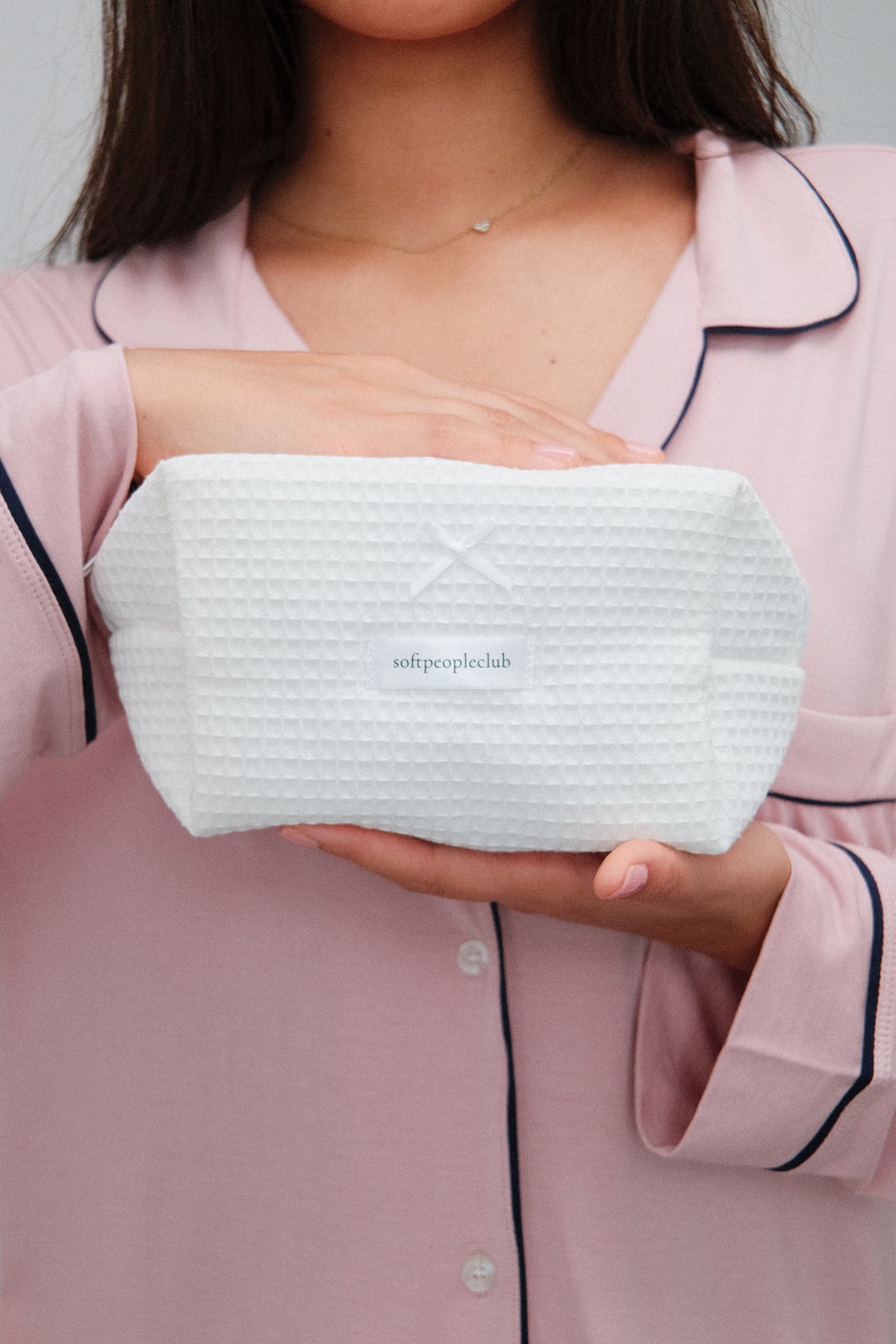 Padded Waffle Makeup Bag in Cream, held by model, close up