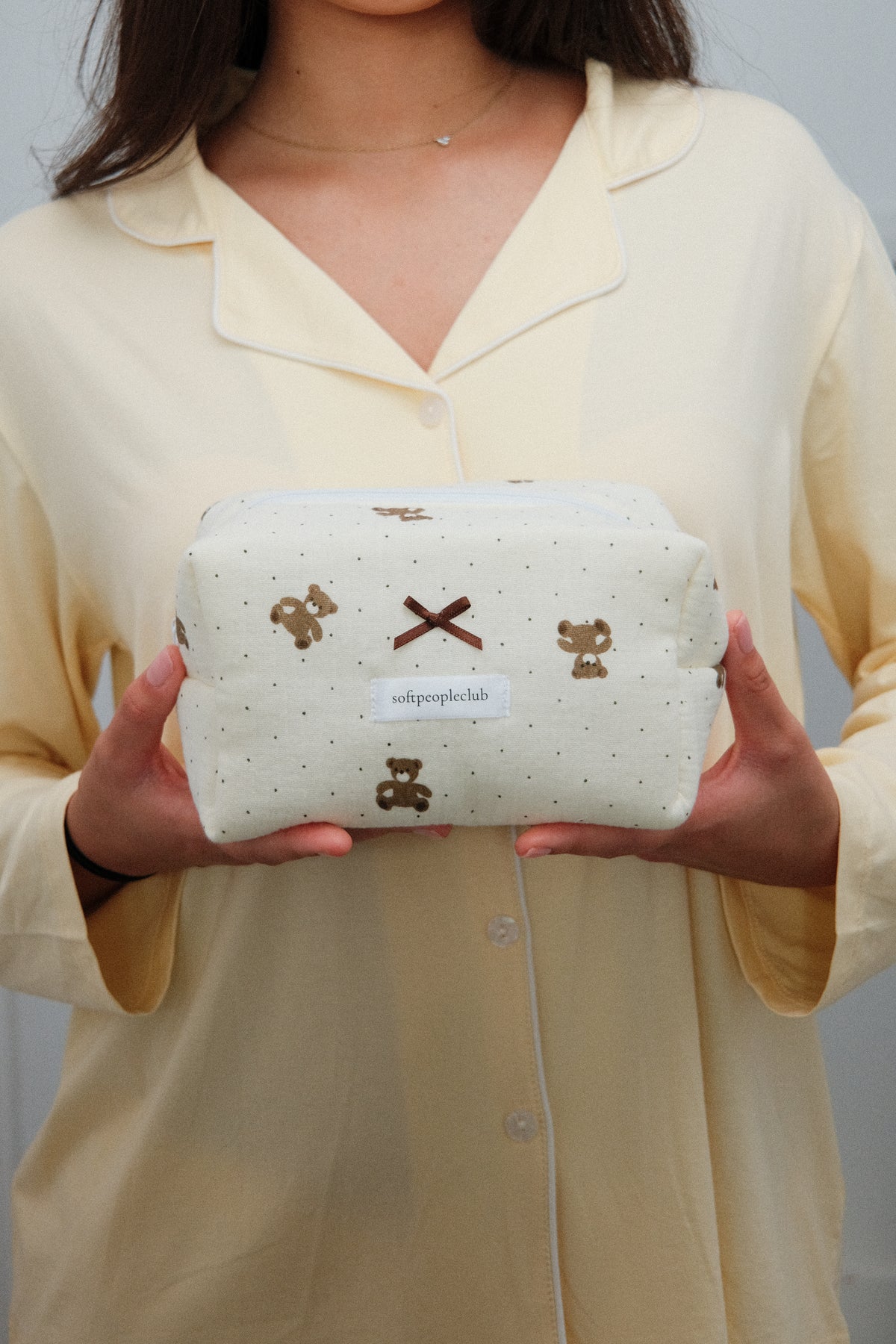 Padded Teddy Dot Makeup Bag, held by model, close up