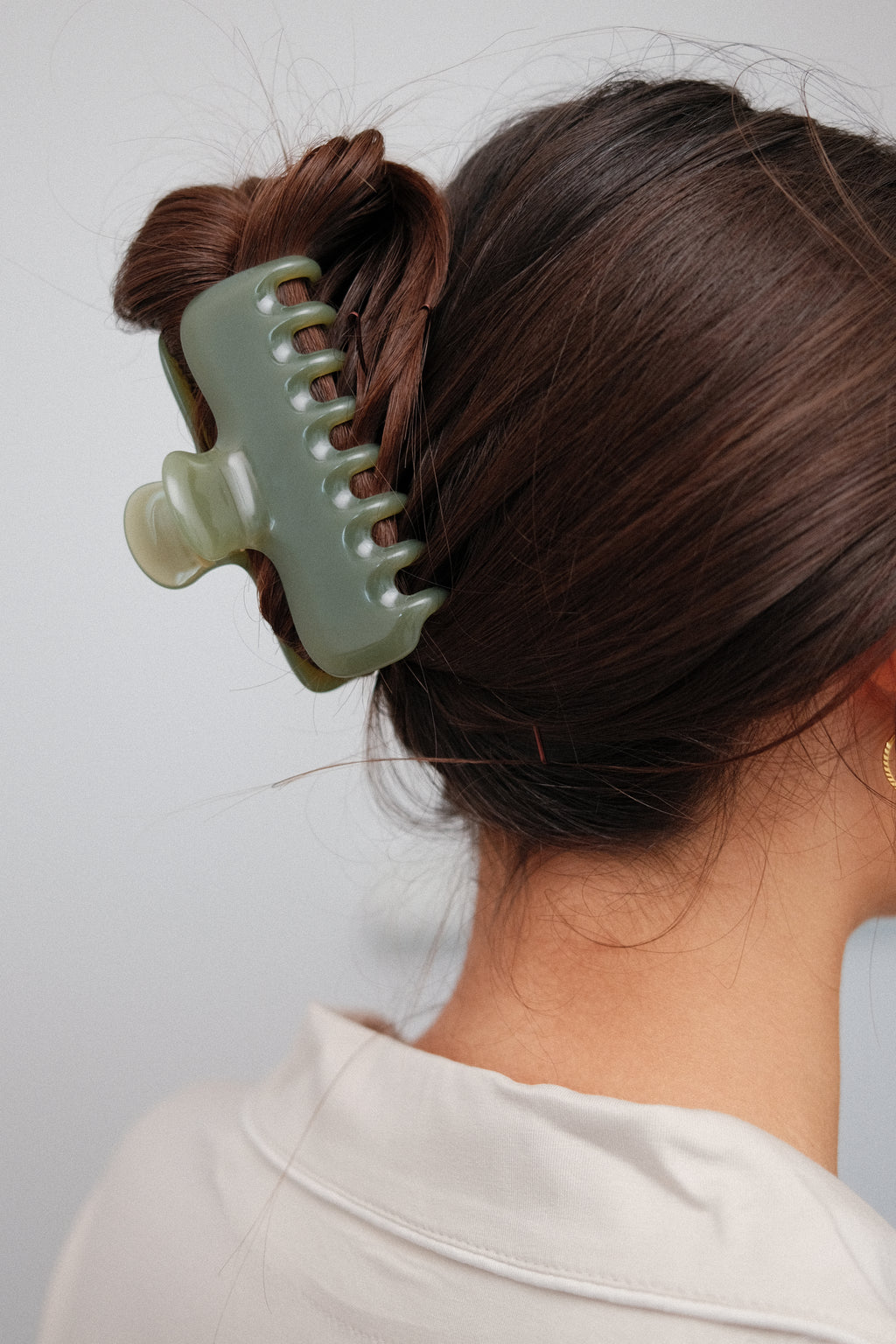 Jelly Claw Clip in Olive, worn in hair, close up