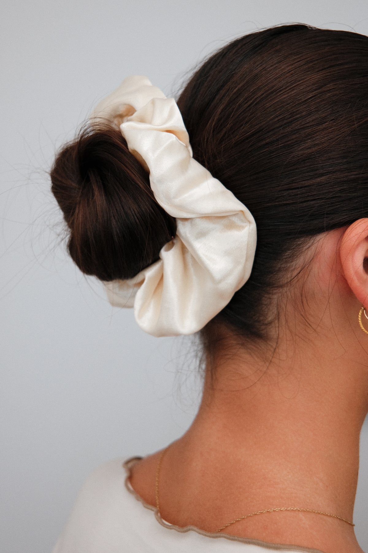 Satin Scrunchie in Butter, worn in hair, close up